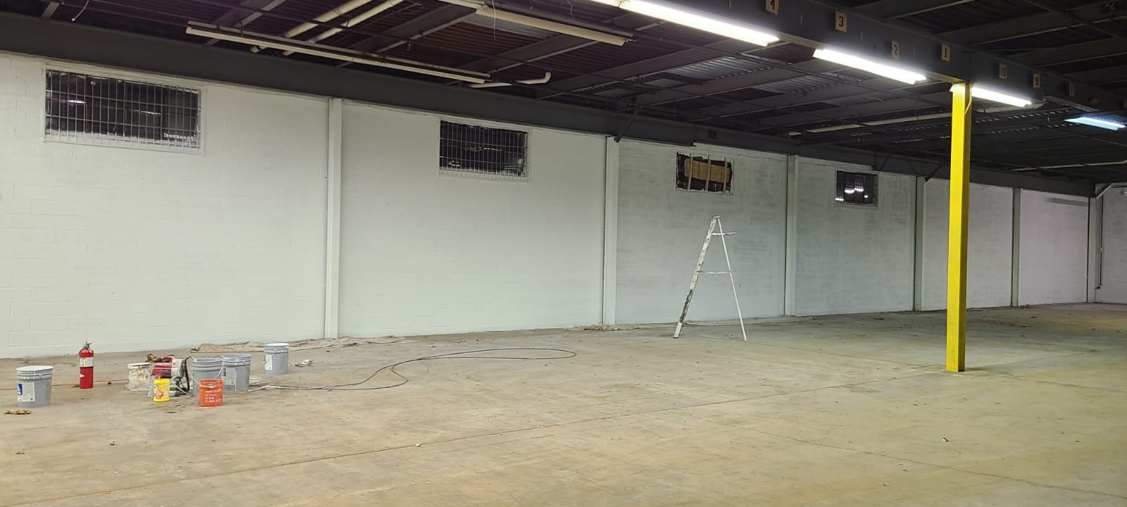 Finishing painting a warehouse wall white
