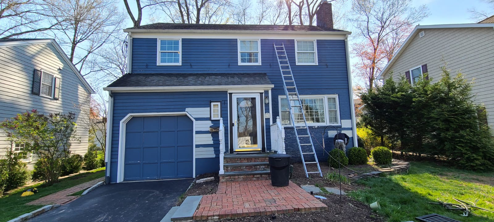 Painting the exterior of a two story house blue